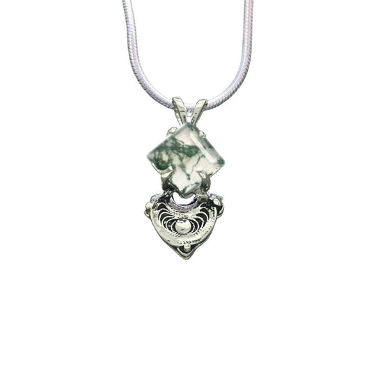 Necklace with a green stone pendant on a white background