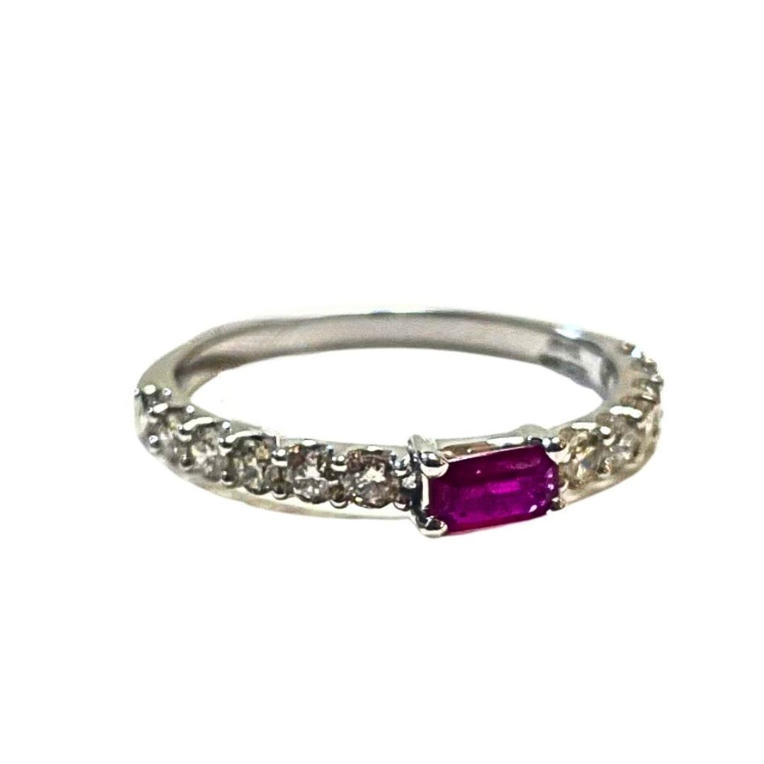 Silver ring with a purple gemstone on a white background