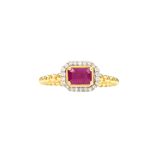 Gold ring with a pink gemstone on a white background