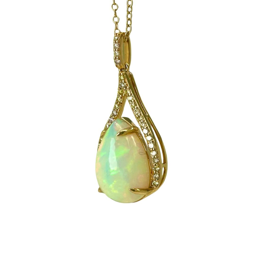 Gold pendant with a teardrop-shaped opal stone on a white background