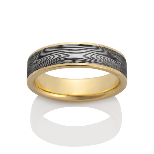 Yellow gold ring with a textured, patterned center on a white background.