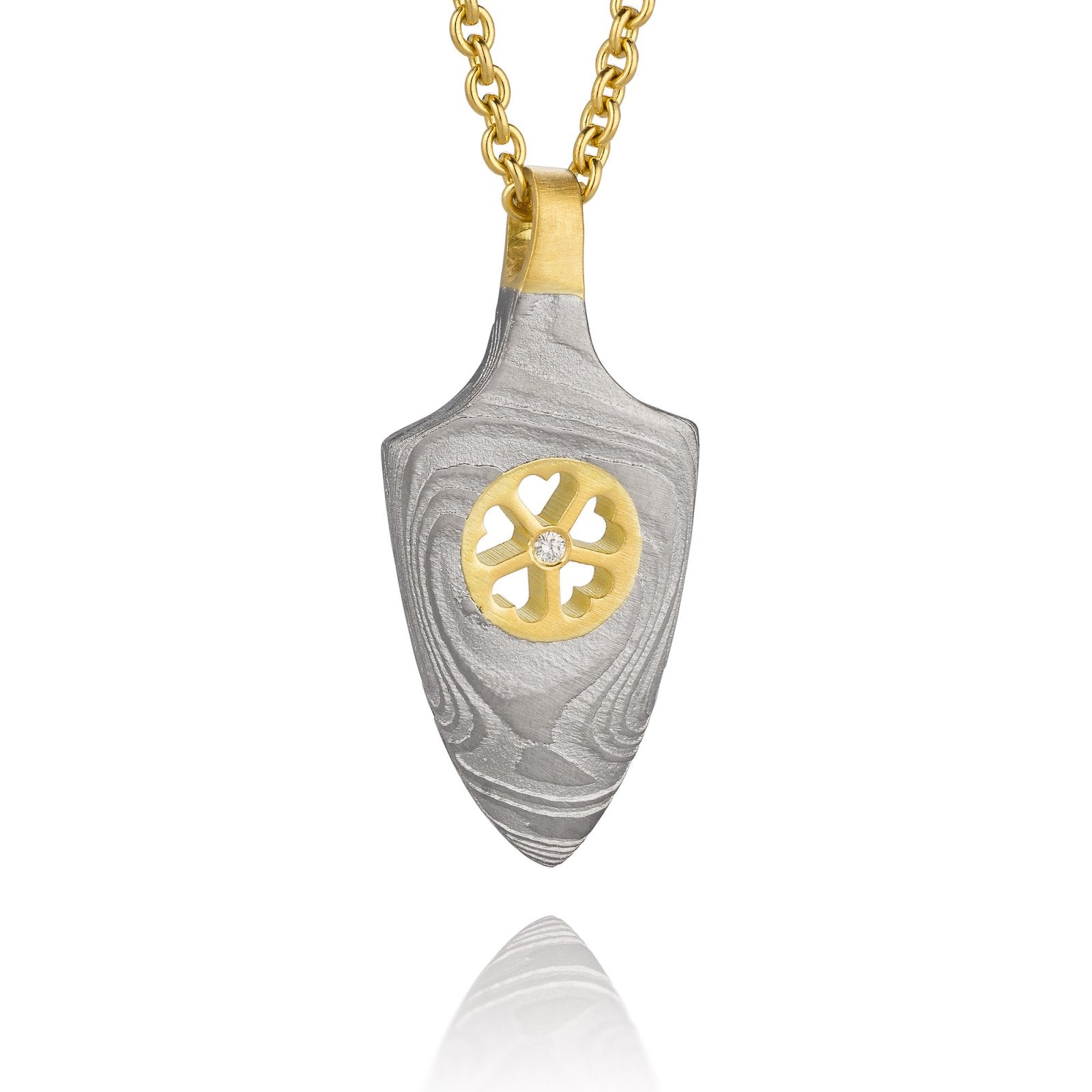 Gold shield-shaped Damascus necklace on a white background. 