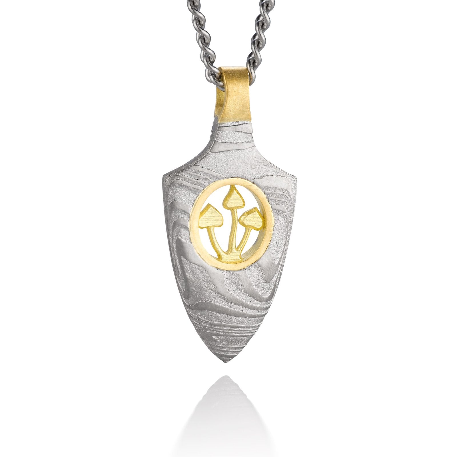 Gold shield-shaped Damascus necklace on a white background. 
