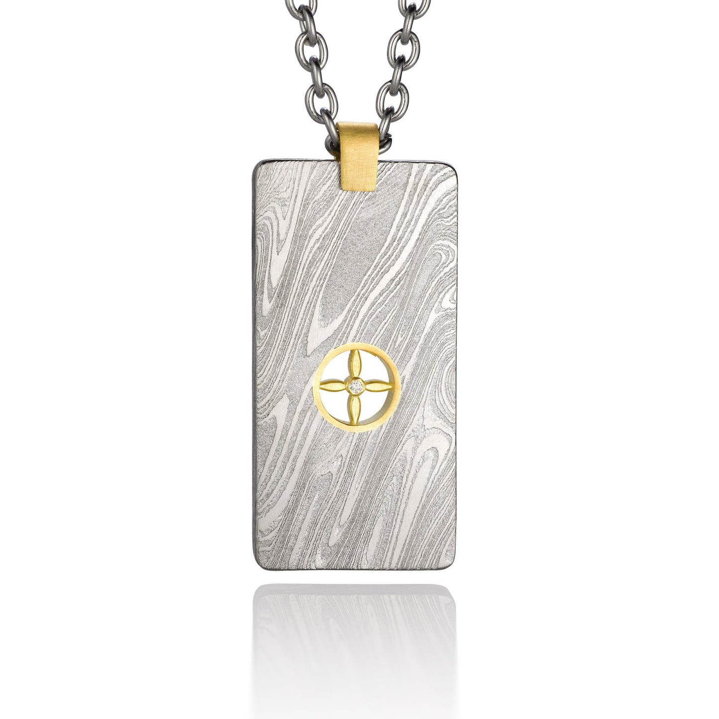 Silver shield-shaped Damascus necklace on a white background. 