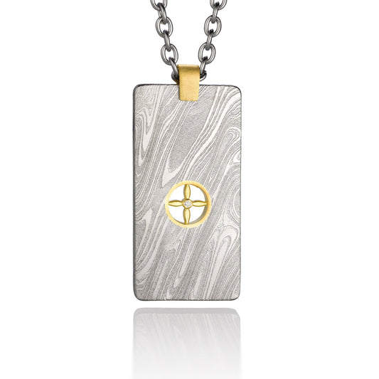 Silver shield-shaped Damascus necklace on a white background. 