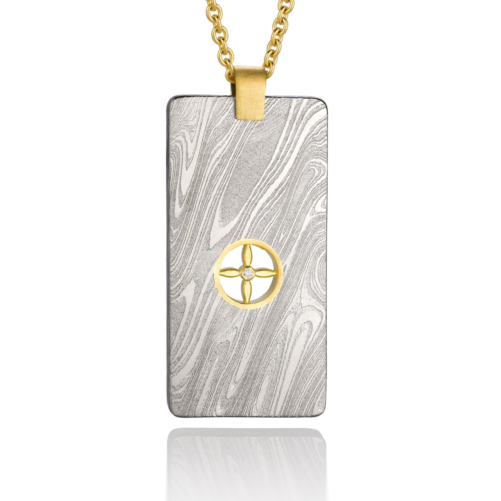 Gold shield-shaped Damascus necklace on a white background. 