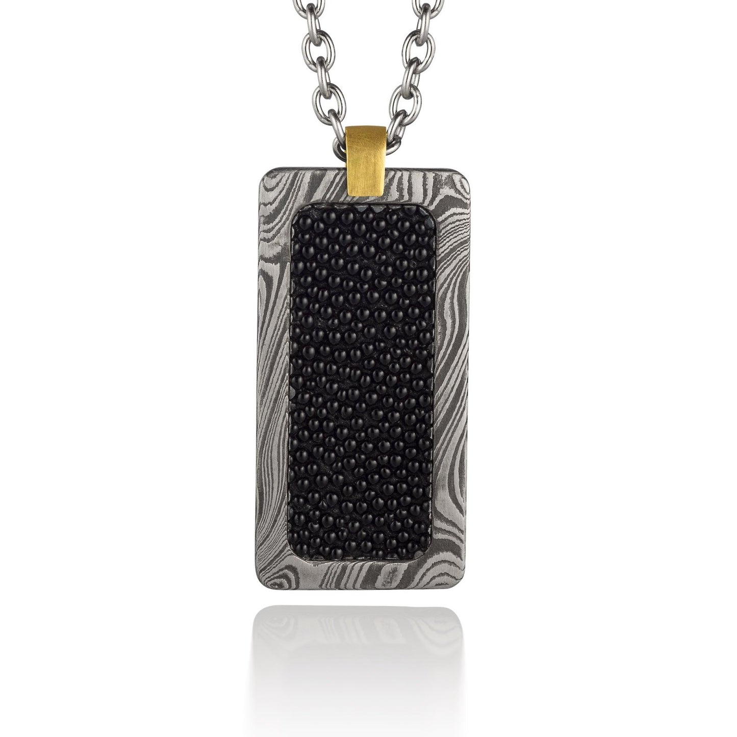 Silver rectangular pendant with a black center piece and a gold top, on a white background.