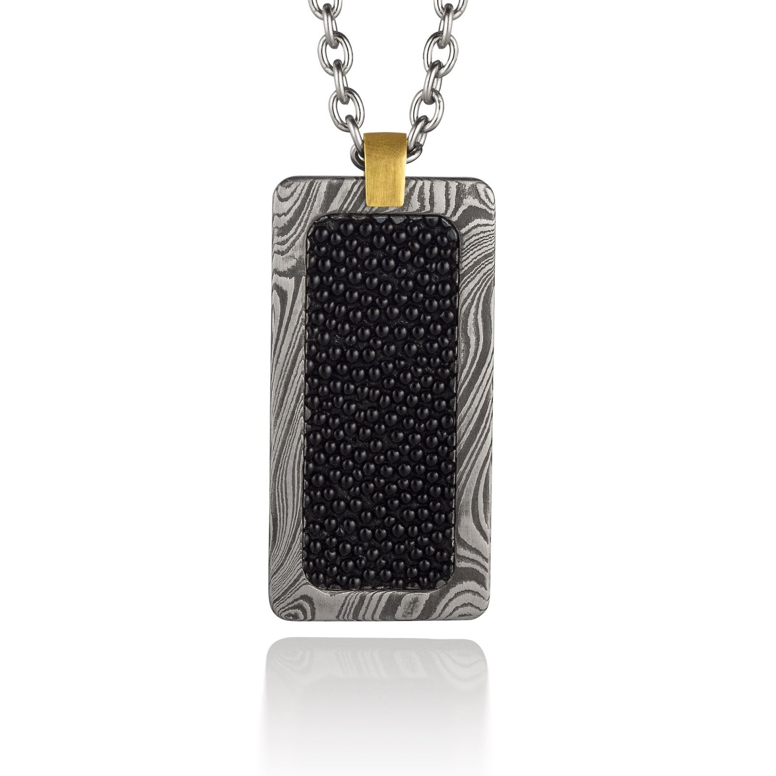 Silver rectangular pendant with a black center piece and a gold top, on a white background.