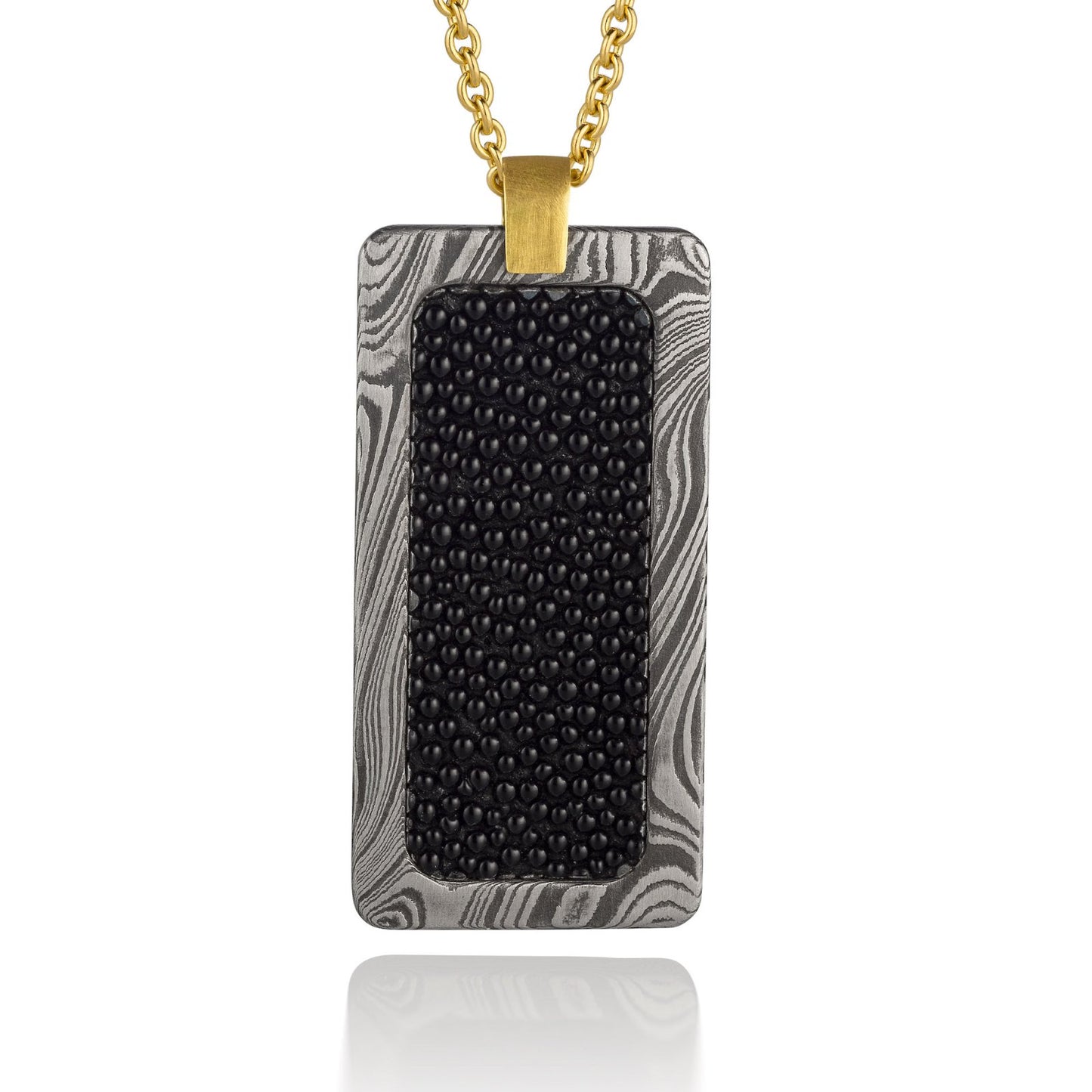 Silver rectangular pendant with a black center piece and a gold top, on a white background.