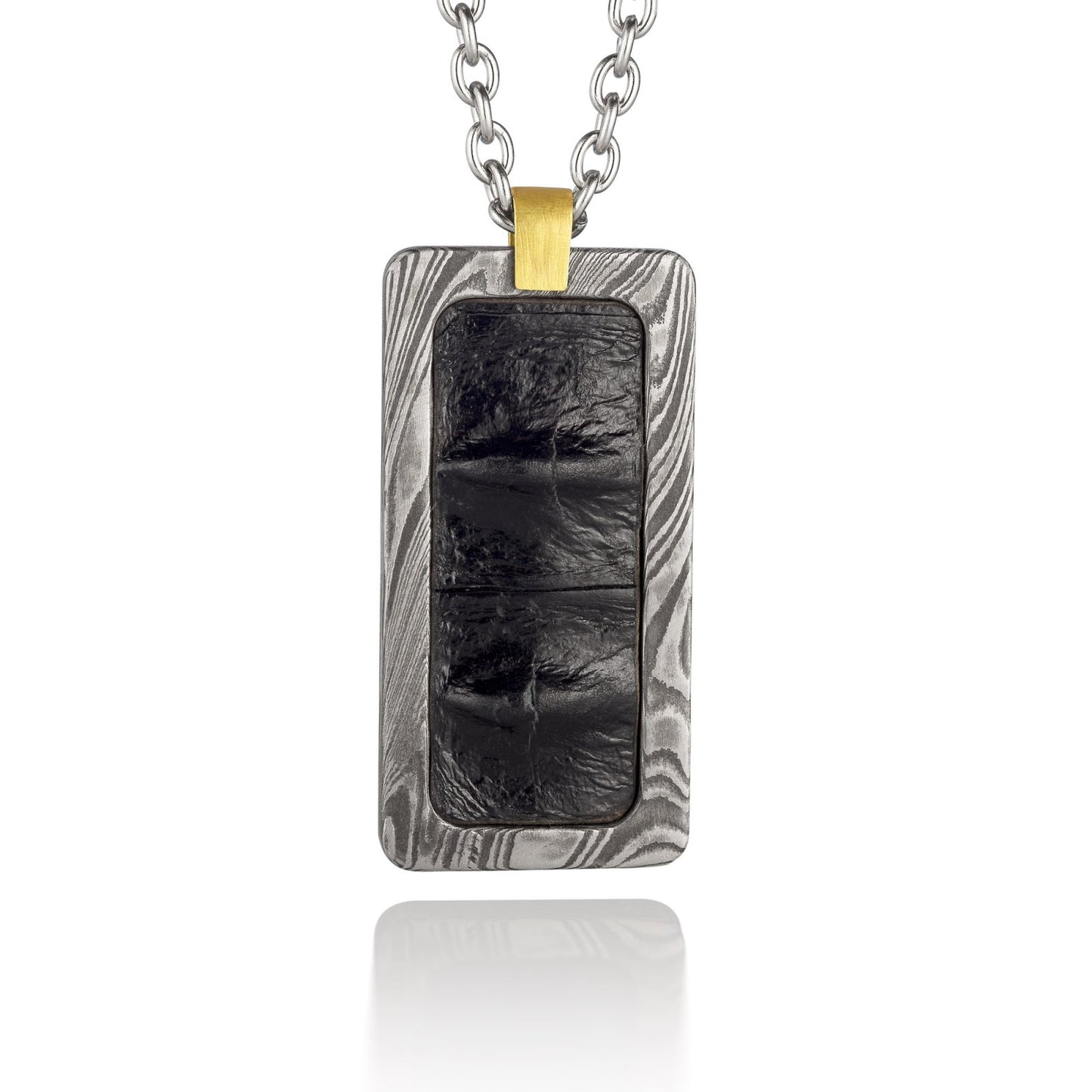 Silver rectangular pendant with a black center piece and a gold top, on a white background.