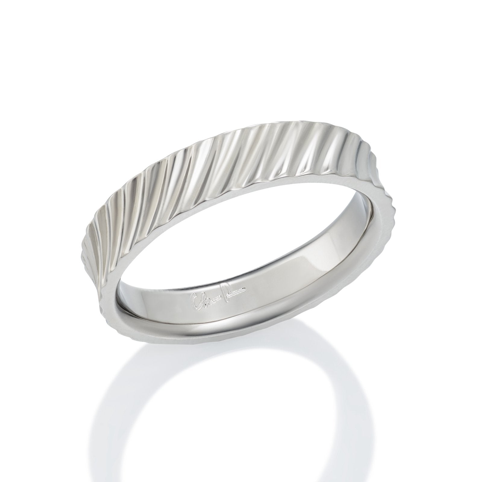 Silver ring with a textured, wavy pattern on a white background.