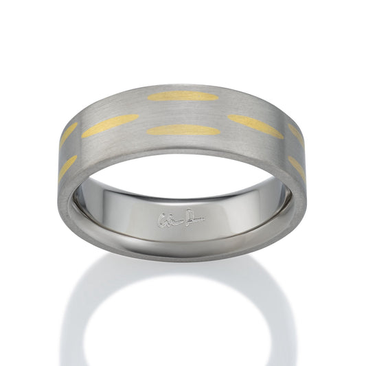 Two-tone silver and  gold ring with a textured, striped pattern on a white backgroun