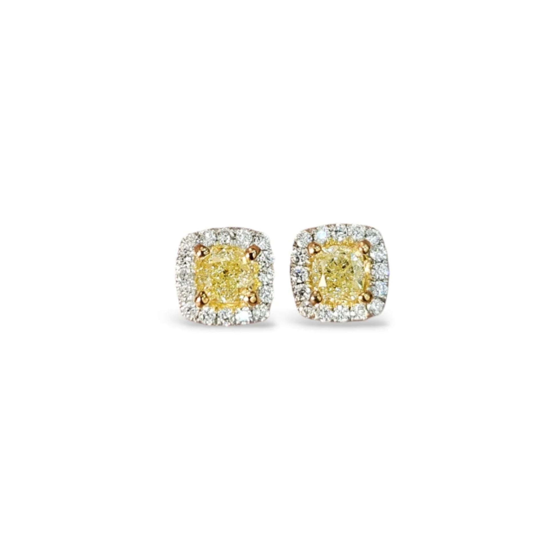 Pair of yellow diamond earrings on a white background
