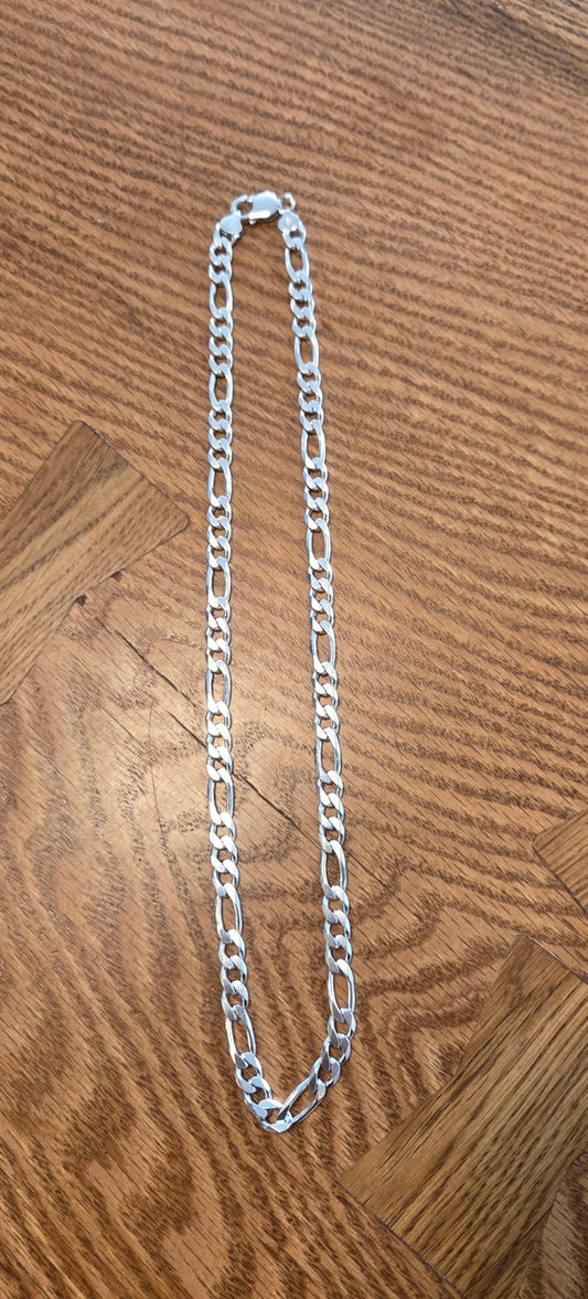 Silver chain on a wooden surface