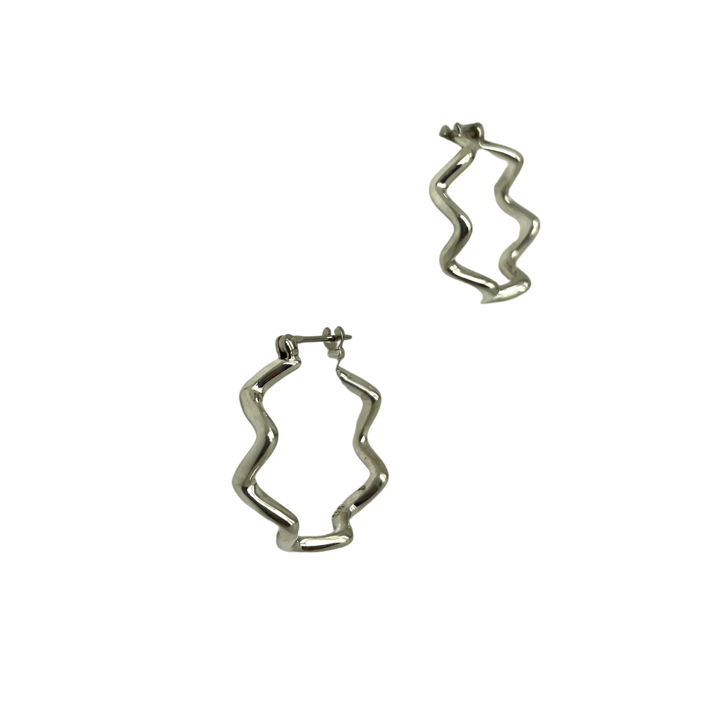 Silver wavy hoop earrings on a white background