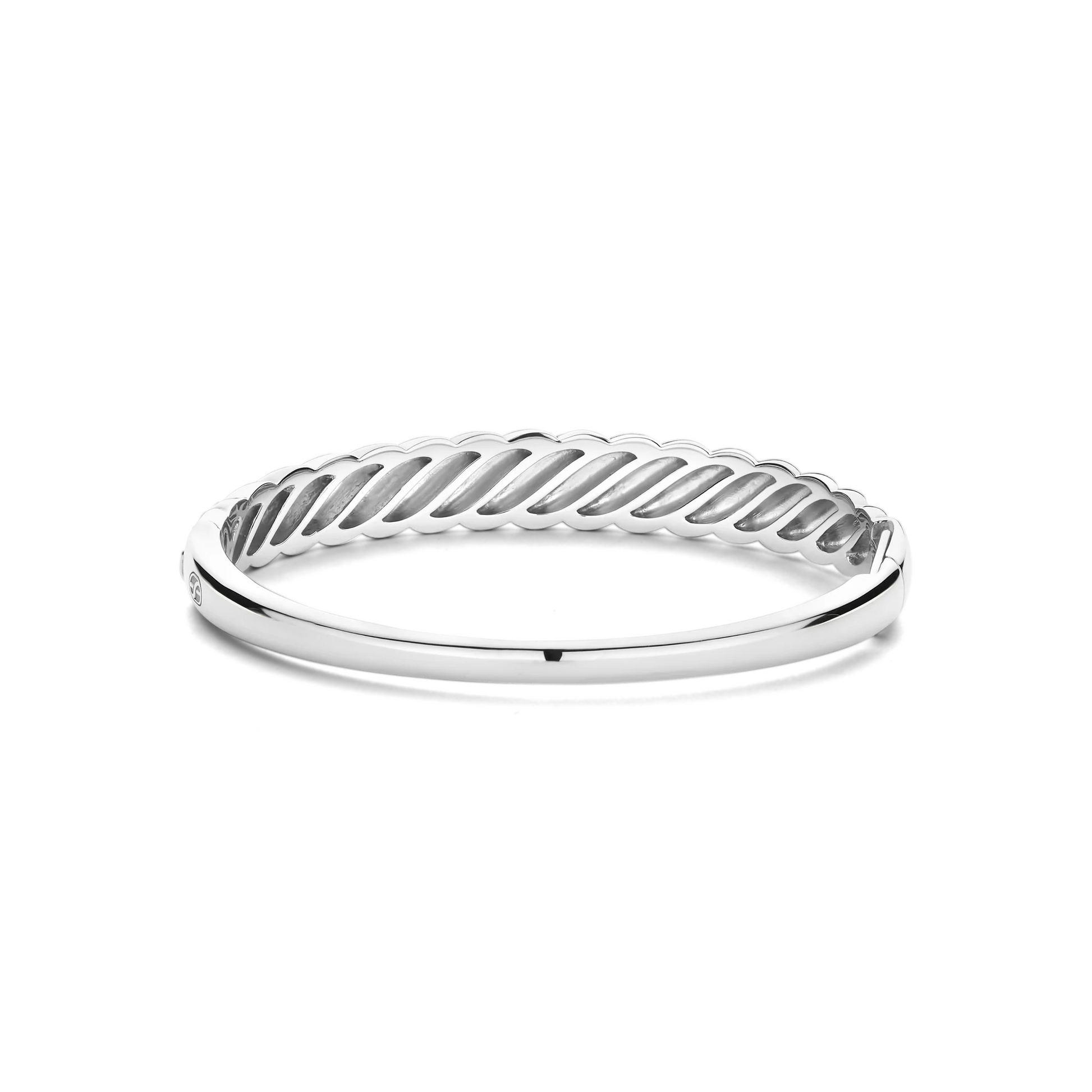 Silver ring with a wavy design on a white background