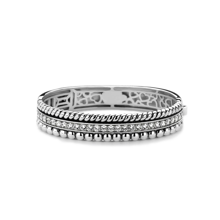 Stack of silver rings with intricate designs on a white background