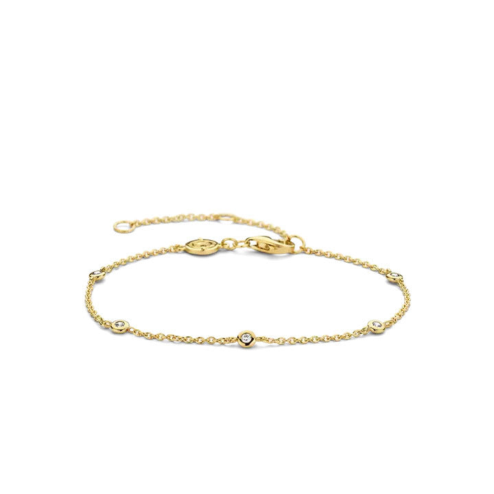 Gold bracelet with small round stones on a white background