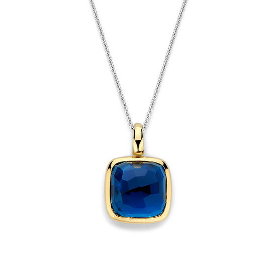 Gold pendant with a blue gemstone on a white background
