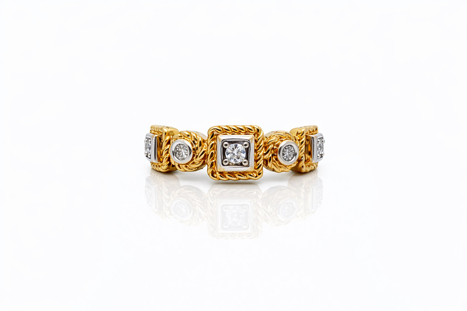 Gold ring with diamond accents on a white background