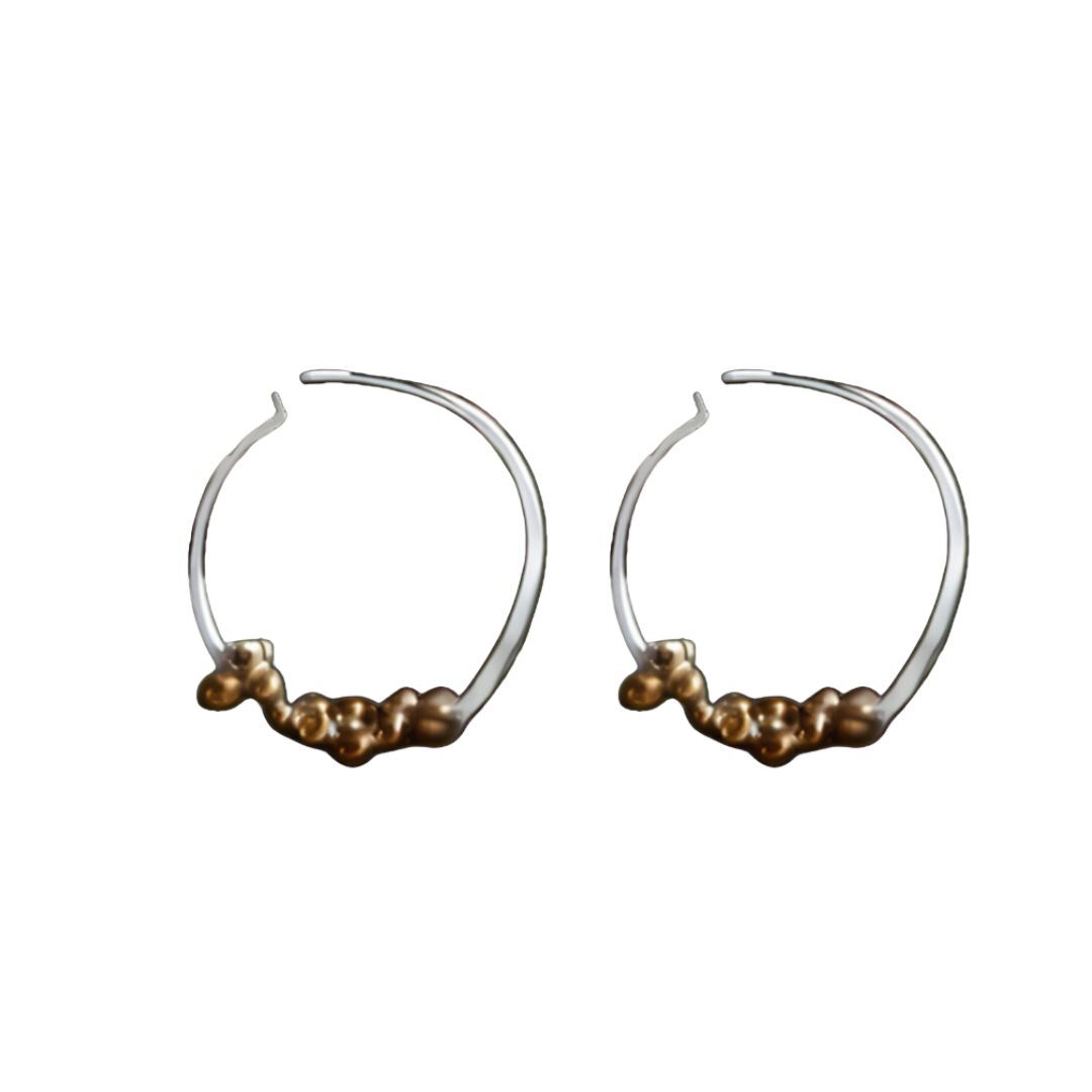Pair of hoop earrings with small beads on a white background