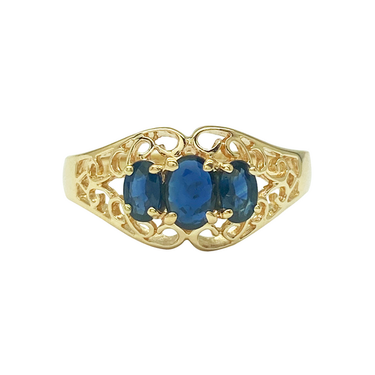 Yellow gold three-stone sapphire ring with filigree.