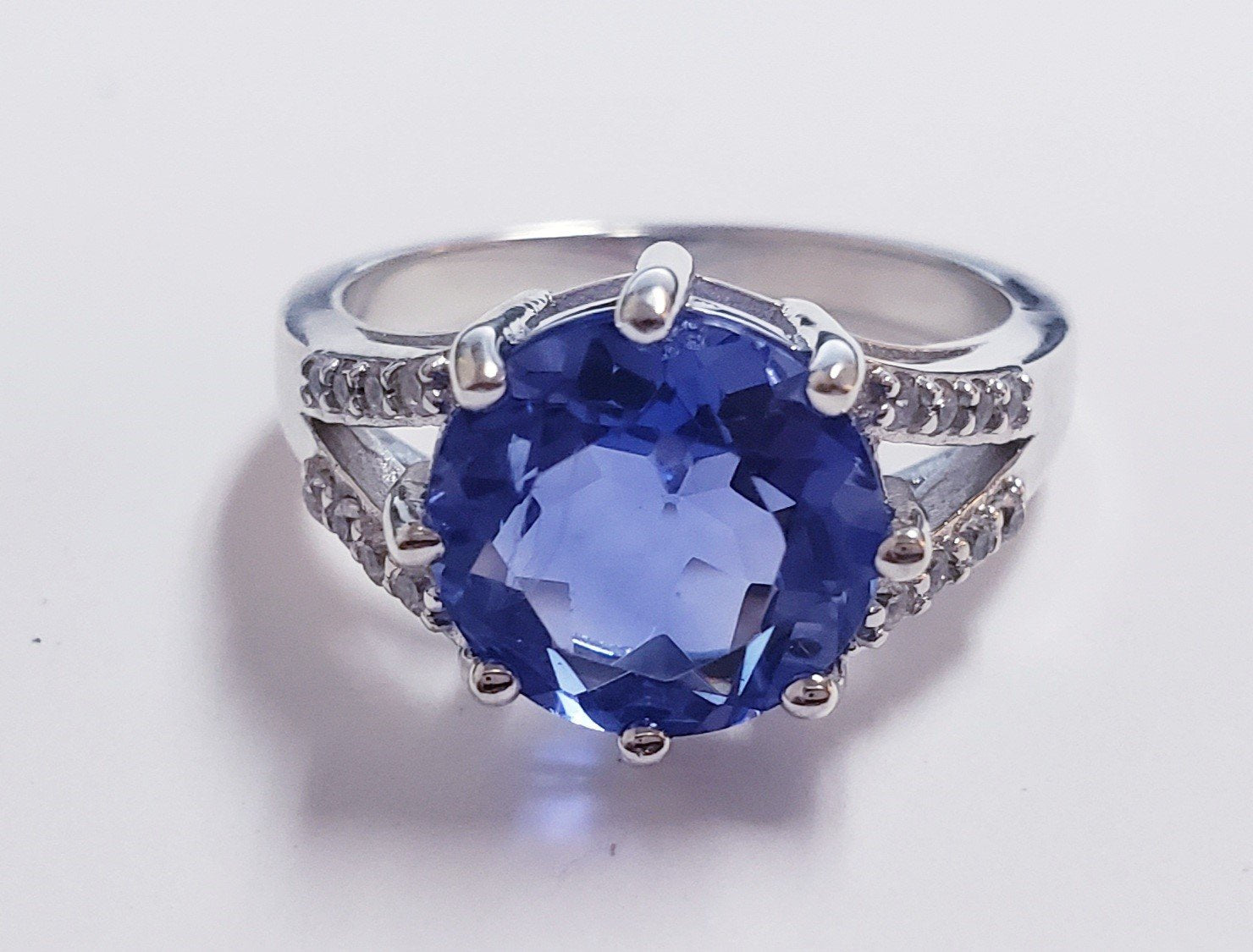 Silver ring with a large, round, blue center stone