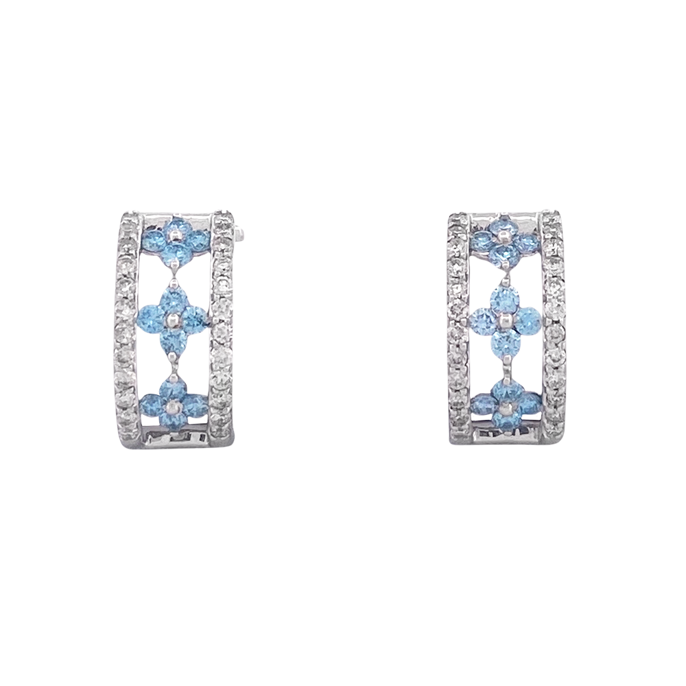 Pair of silver huggie earrings with three rows of blue and white gemstones set in a floral pattern.